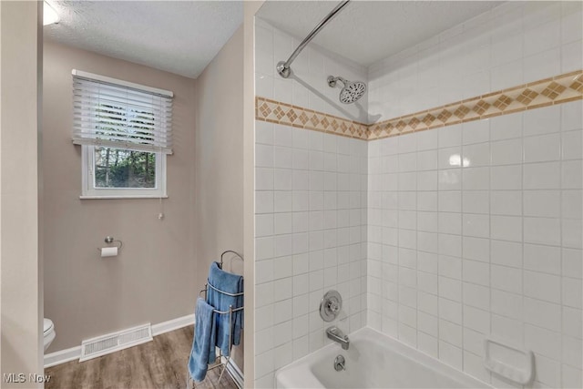 4090 Ridgeview Rd, Cleveland, OH 44144 - full bathroom with a textured ceiling, shower / tub combination, and wood finished floors