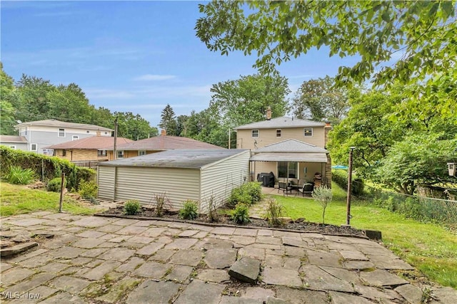 4090 Ridgeview Rd, Cleveland, OH 44144 - back of house with a patio, a fenced backyard, a chimney, and an outdoor structure