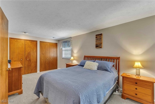 4090 Ridgeview Rd, Cleveland, OH 44144 - carpeted bedroom featuring multiple closets and a textured ceiling