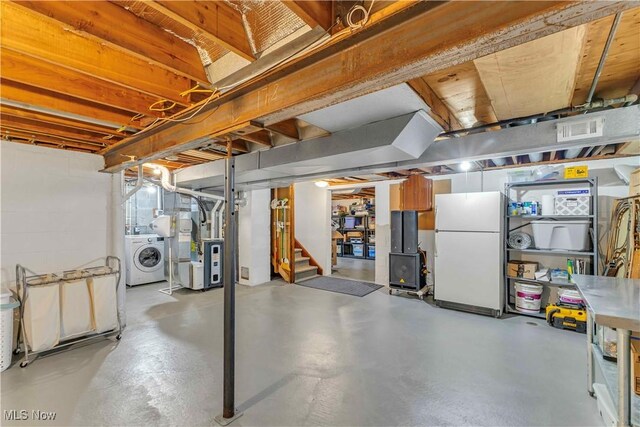 4090 Ridgeview Rd, Cleveland, OH 44144 - unfinished below grade area featuring freestanding refrigerator, washer / clothes dryer, stairs, and heating unit