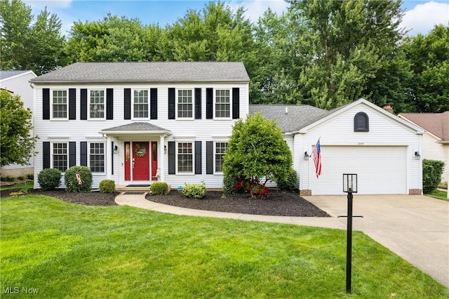 3049 Deercrest Path, Stow, OH 44224 - colonial house with driveway, an attached garage, a front lawn, and roof with shingles