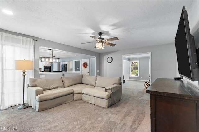 3049 Deercrest Path, Stow, OH 44224 - living area featuring carpet floors, a textured ceiling, a ceiling fan, and a chandelier