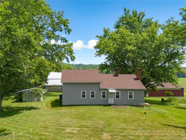 12456 Sheldon Rd, Mantua, OH 44255 - back of property featuring a chimney and a lawn