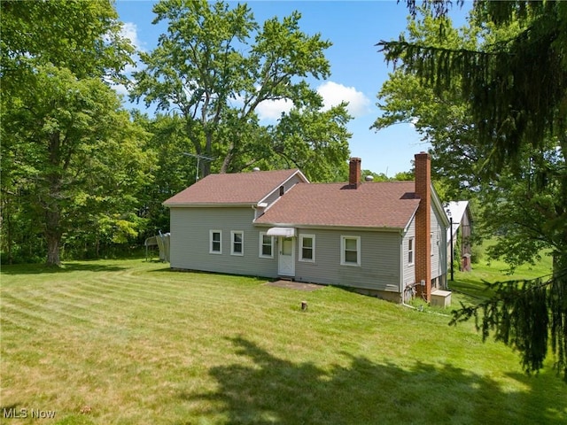 12456 Sheldon Rd, Mantua, OH 44255 - back of property featuring a lawn and a chimney