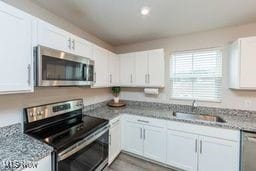 105 Vesper Cir, Lodi, OH 44254 - kitchen with appliances with stainless steel finishes, white cabinets, light stone counters, and recessed lighting