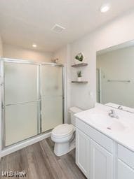 105 Vesper Cir, Lodi, OH 44254 - full bathroom with vanity, a shower stall, wood finished floors, and recessed lighting