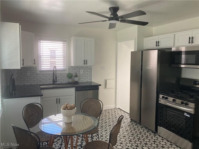 6704 Northcliff Ave, Brooklyn, OH 44144 - kitchen with stainless steel appliances, dark countertops, white cabinetry, tasteful backsplash, and light flooring