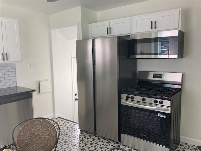 6704 Northcliff Ave, Brooklyn, OH 44144 - kitchen featuring appliances with stainless steel finishes, white cabinetry, and tasteful backsplash