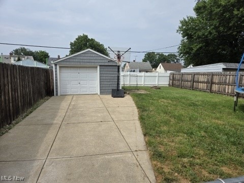 6704 Northcliff Ave, Brooklyn, OH 44144 - fenced backyard with a detached garage, concrete driveway, and an outbuilding