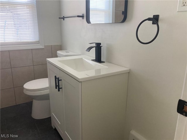 6704 Northcliff Ave, Brooklyn, OH 44144 - bathroom featuring vanity, plenty of natural light, tile patterned flooring, and tile walls