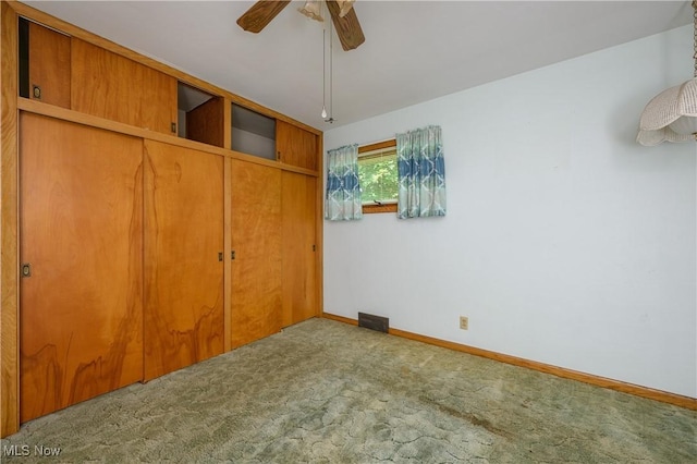 731 Hemlock St NW, Massillon, OH 44647 - unfurnished bedroom featuring carpet, a closet, and ceiling fan