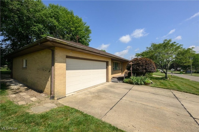 731 Hemlock St NW, Massillon, OH 44647 - view of property exterior with brick siding and a detached garage