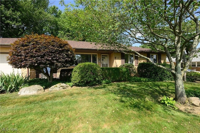 731 Hemlock St NW, Massillon, OH 44647 - view of property hidden behind natural elements featuring a front yard and an attached garage