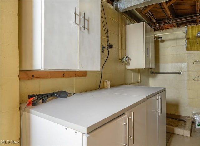 731 Hemlock St NW, Massillon, OH 44647 - laundry room with concrete block wall and water heater