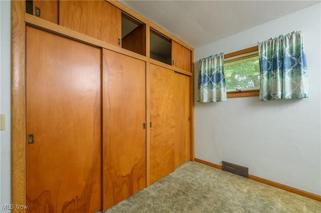 731 Hemlock St NW, Massillon, OH 44647 - unfurnished bedroom featuring carpet flooring and baseboards