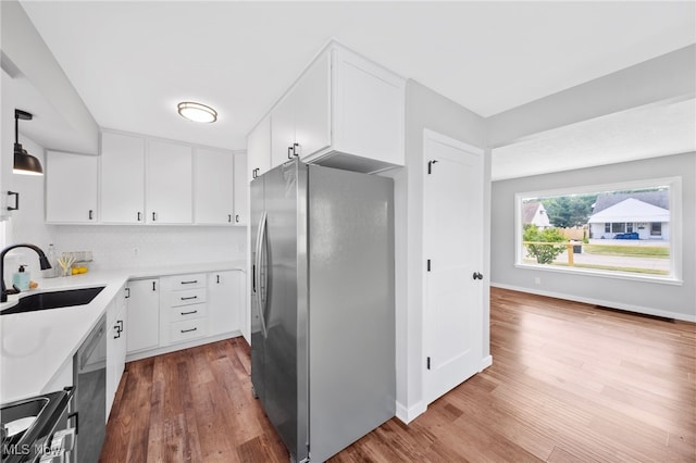 3763 Orchard St, Mogadore, OH 44260 - kitchen with appliances with stainless steel finishes, wood finished floors, white cabinets, and light countertops