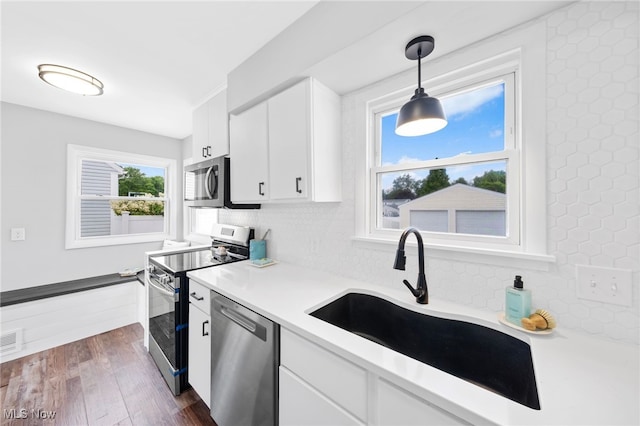 3763 Orchard St, Mogadore, OH 44260 - kitchen with stainless steel appliances, light countertops, white cabinetry, and backsplash