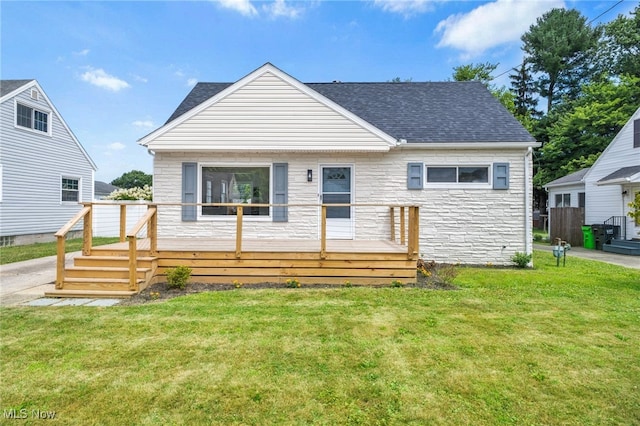 3763 Orchard St, Mogadore, OH 44260 - bungalow-style home with a wooden deck, roof with shingles, a front yard, and stone siding