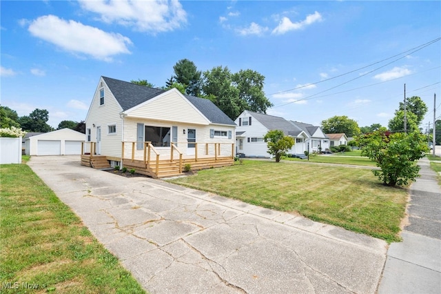 3763 Orchard St, Mogadore, OH 44260 - bungalow-style home with an outbuilding, a garage, a front yard, and roof with shingles