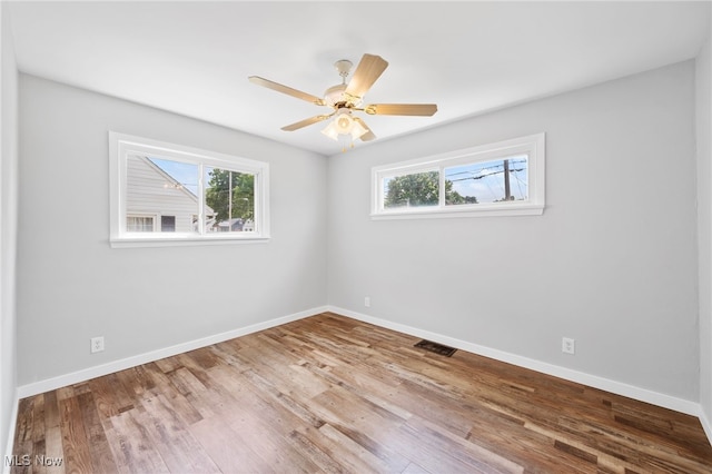 3763 Orchard St, Mogadore, OH 44260 - unfurnished room with healthy amount of natural light, wood finished floors, and a ceiling fan
