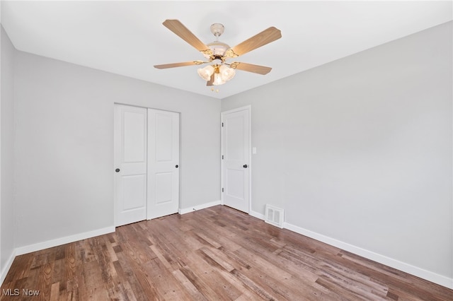 3763 Orchard St, Mogadore, OH 44260 - unfurnished bedroom with wood finished floors, a closet, and ceiling fan