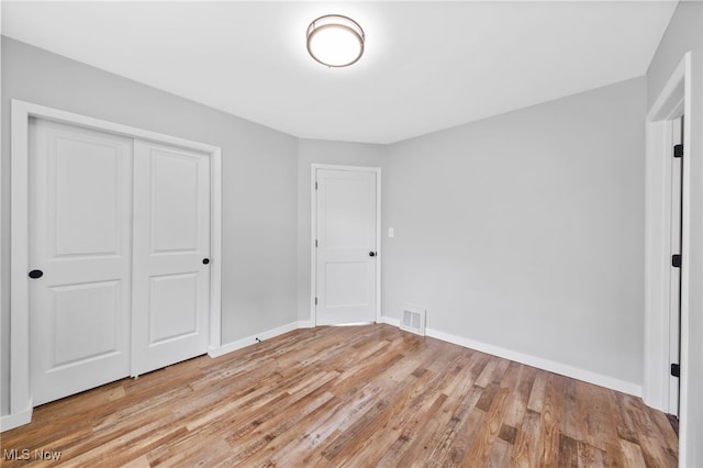 3763 Orchard St, Mogadore, OH 44260 - unfurnished bedroom with light wood finished floors and a closet
