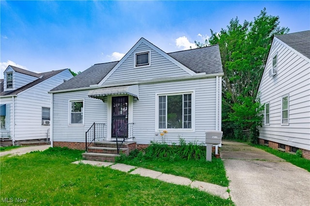 21304 Watson Rd, Maple Heights, OH 44137 - bungalow-style house featuring roof with shingles, a front lawn, and cooling unit