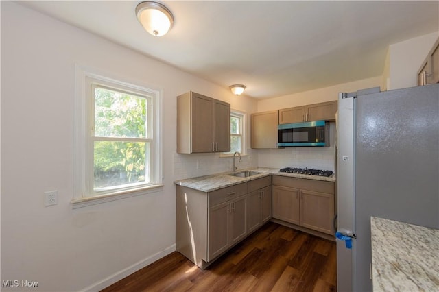 21304 Watson Rd, Maple Heights, OH 44137 - kitchen featuring appliances with stainless steel finishes, dark wood-type flooring, healthy amount of natural light, and decorative backsplash