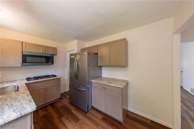 21304 Watson Rd, Maple Heights, OH 44137 - kitchen featuring appliances with stainless steel finishes, dark wood-style floors, tasteful backsplash, and light stone countertops