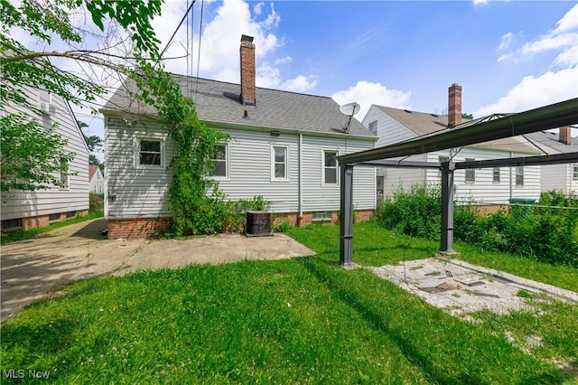 21304 Watson Rd, Maple Heights, OH 44137 - rear view of property featuring a yard and a chimney