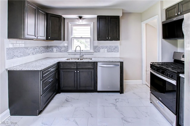 16005 Mendota Ave, Maple Heights, OH 44137 - kitchen featuring appliances with stainless steel finishes, light marble finish flooring, light stone counters, and backsplash