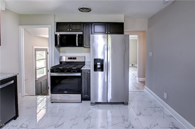 16005 Mendota Ave, Maple Heights, OH 44137 - kitchen featuring appliances with stainless steel finishes, light marble finish flooring, and light stone counters
