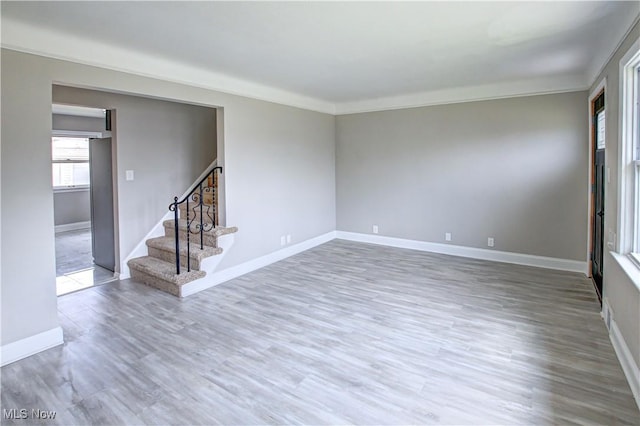 16005 Mendota Ave, Maple Heights, OH 44137 - empty room with stairs, wood finished floors, and crown molding