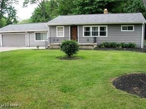 25716 Westwood Rd, Westlake, OH 44145 - ranch-style house featuring a garage, a front lawn, driveway, and a chimney