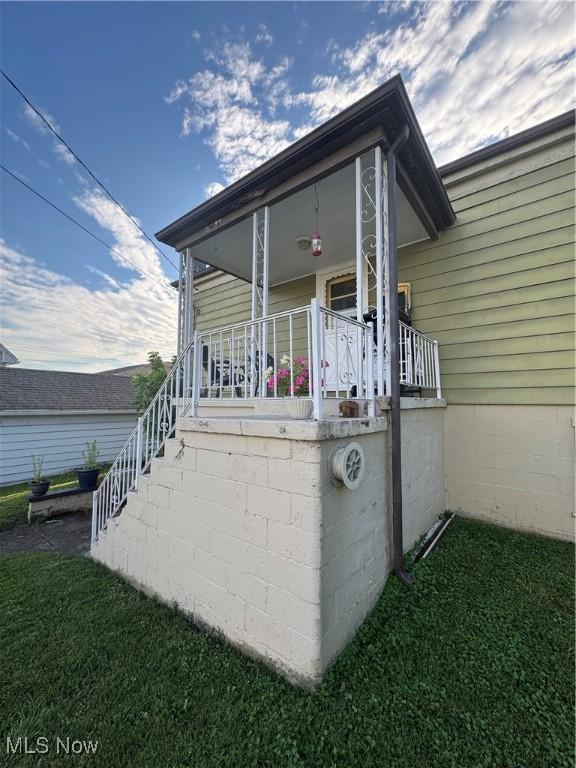 3868 Adams Ave, Shadyside, OH 43947 - view of side of property with stairway, covered porch, and a yard