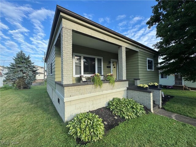 3868 Adams Ave, Shadyside, OH 43947 - view of front facade with a front lawn, covered porch, and brick siding