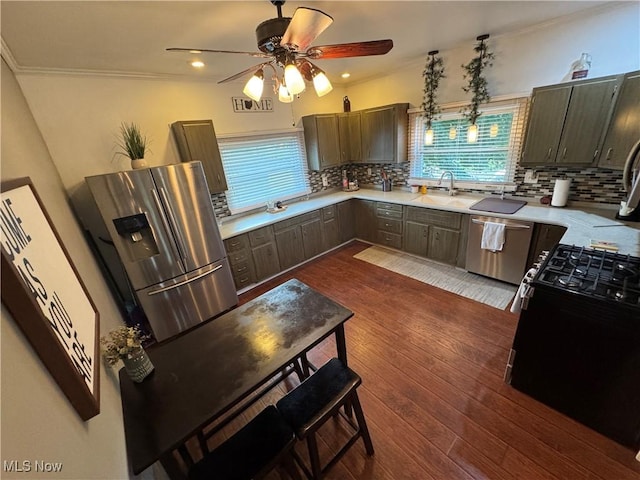 3868 Adams Ave, Shadyside, OH 43947 - kitchen with stainless steel appliances, a ceiling fan, light countertops, decorative backsplash, and crown molding