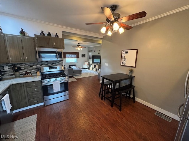 3868 Adams Ave, Shadyside, OH 43947 - kitchen featuring stainless steel appliances, ceiling fan, ornamental molding, light countertops, and decorative backsplash