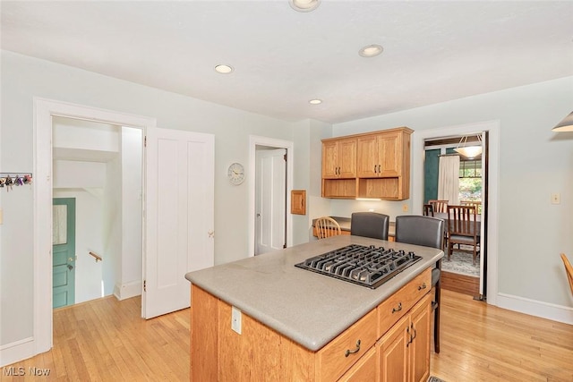 1539 Compton Rd, Cleveland Heights, OH 44118 - kitchen featuring stainless steel gas stovetop, light wood-style floors, a kitchen island, recessed lighting, and light countertops