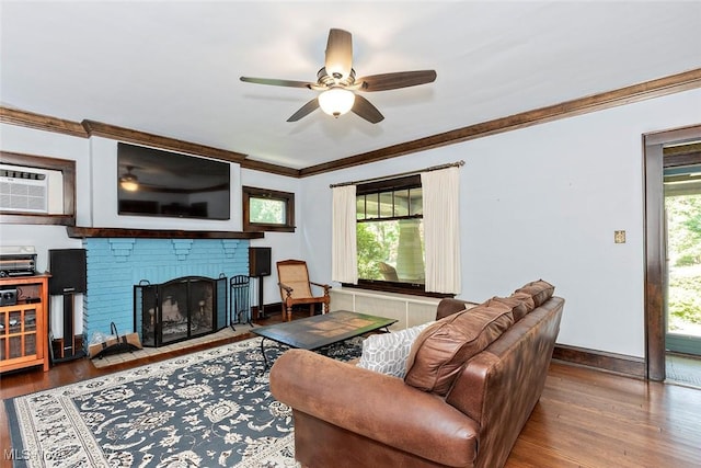 1539 Compton Rd, Cleveland Heights, OH 44118 - living room with crown molding, a ceiling fan, wood finished floors, a brick fireplace, and a wall mounted air conditioner