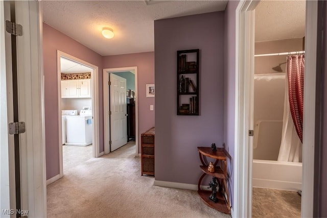 785 Cambridge Ct, Kent, OH 44240 - corridor with washer and clothes dryer, a textured ceiling, and light carpet