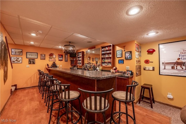 785 Cambridge Ct, Kent, OH 44240 - indoor bar with light wood-style flooring, recessed lighting, and a textured ceiling