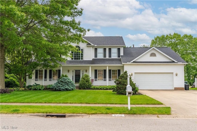 3342 Ramsgate St NW, North Canton, OH 44720 - view of front facade with a porch, concrete driveway, a garage, and a front lawn