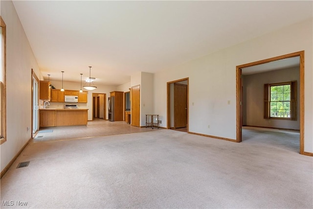 3342 Ramsgate St NW, North Canton, OH 44720 - unfurnished living room with light colored carpet