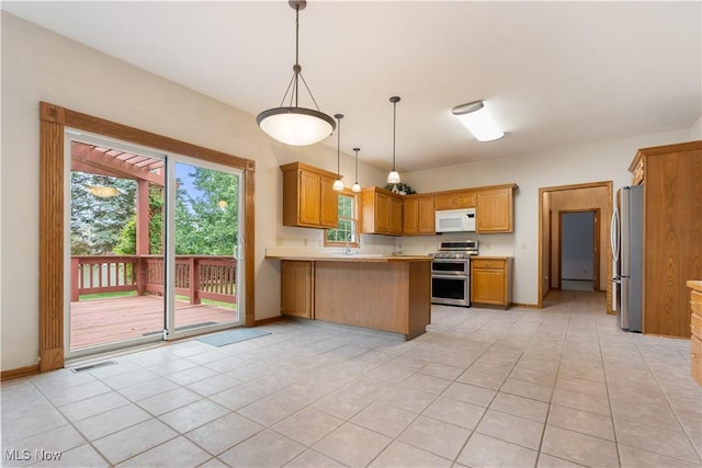 3342 Ramsgate St NW, North Canton, OH 44720 - kitchen featuring stainless steel appliances, a peninsula, light tile patterned floors, light countertops, and pendant lighting