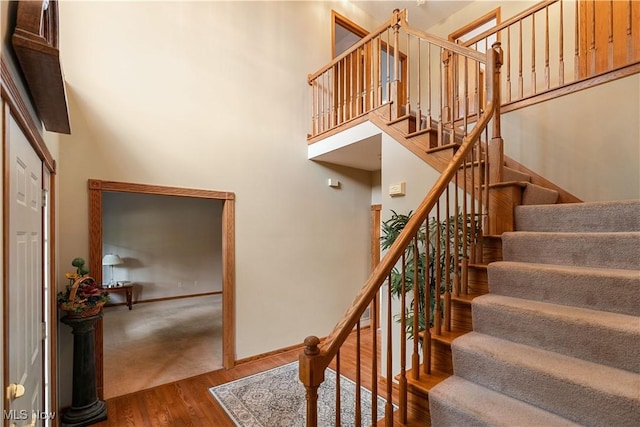3342 Ramsgate St NW, North Canton, OH 44720 - staircase featuring wood finished floors and a towering ceiling