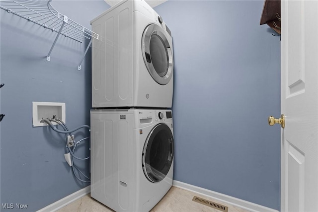 184 Creekledge Ln, Copley, OH 44321 - washroom featuring stacked washer / dryer and baseboards