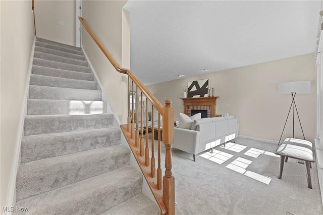 184 Creekledge Ln, Copley, OH 44321 - staircase featuring a fireplace and carpet flooring