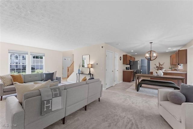 184 Creekledge Ln, Copley, OH 44321 - living area with light carpet, a chandelier, and stairs