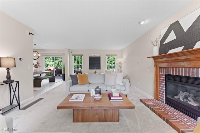 184 Creekledge Ln, Copley, OH 44321 - living area featuring carpet flooring, a fireplace, and plenty of natural light